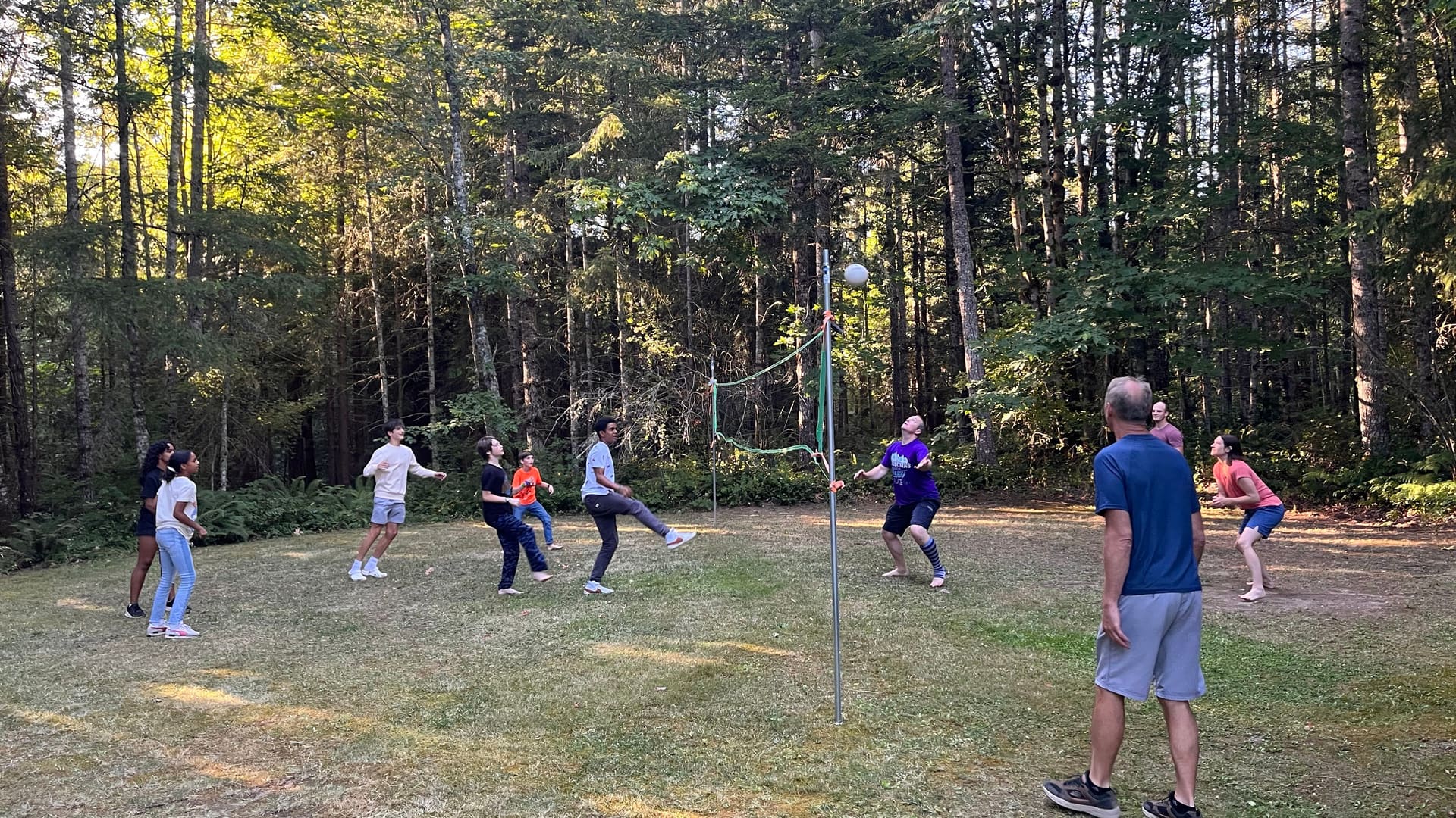 A family game of volleyball in the woods at Blue Mountain Retreat