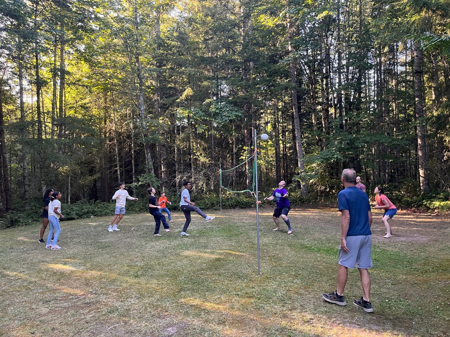 A family game of volleyball in the woods